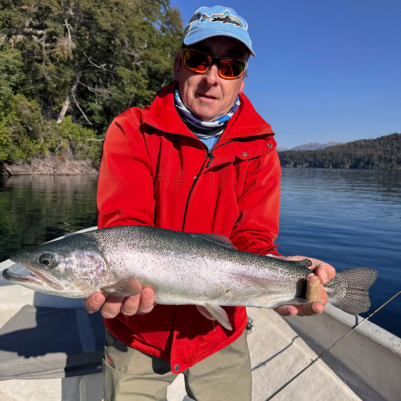 Client with a brown trout on Lake Nahuel Huapi