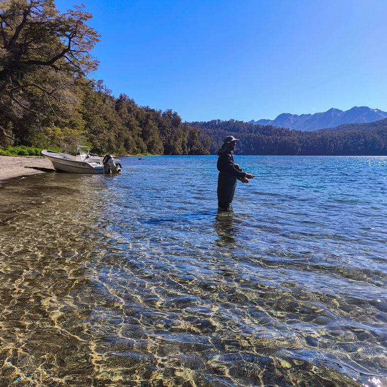 pescador trabajando la costa del lago Nahuel Huapi